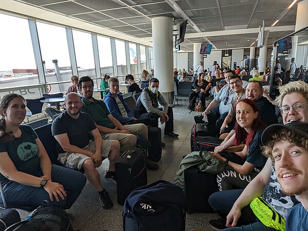 Unterwegs nach Bagkok. (Foto: HTWK Robots) viele Leute sitzen und warten in Flughafen